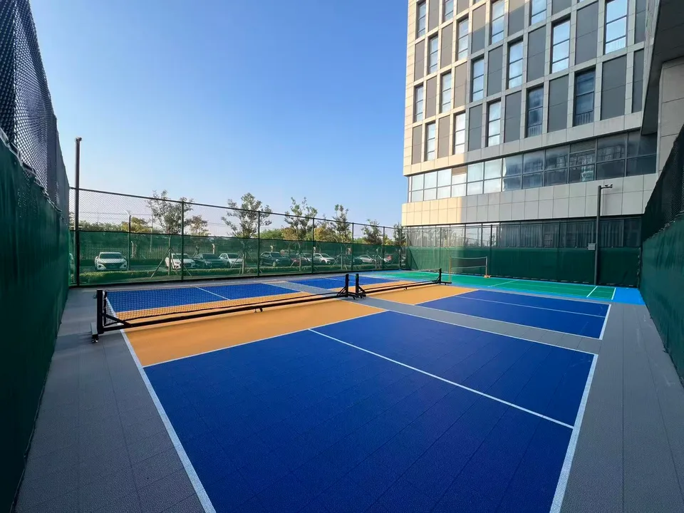 Outdoor racket-sport courts with interlocking flooring