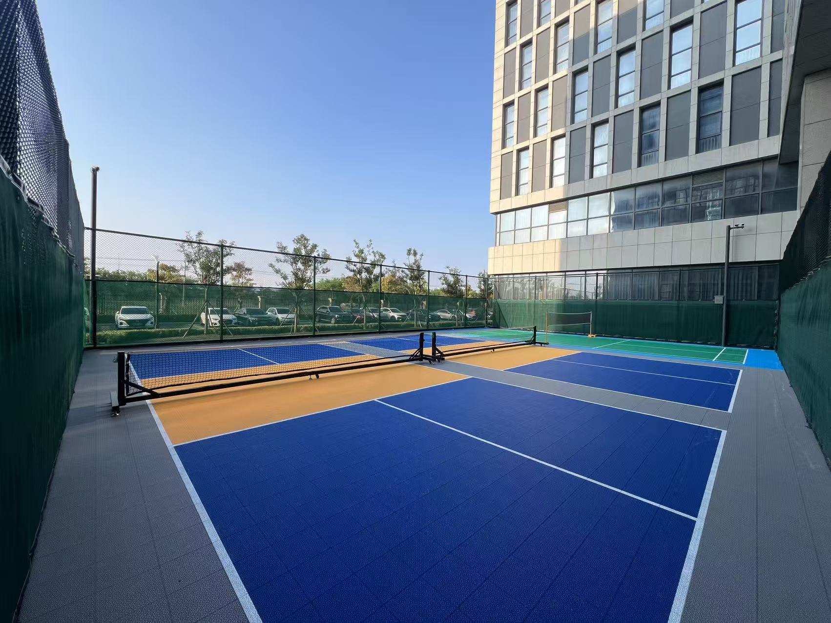 Outdoor racket-sport courts with interlocking flooring