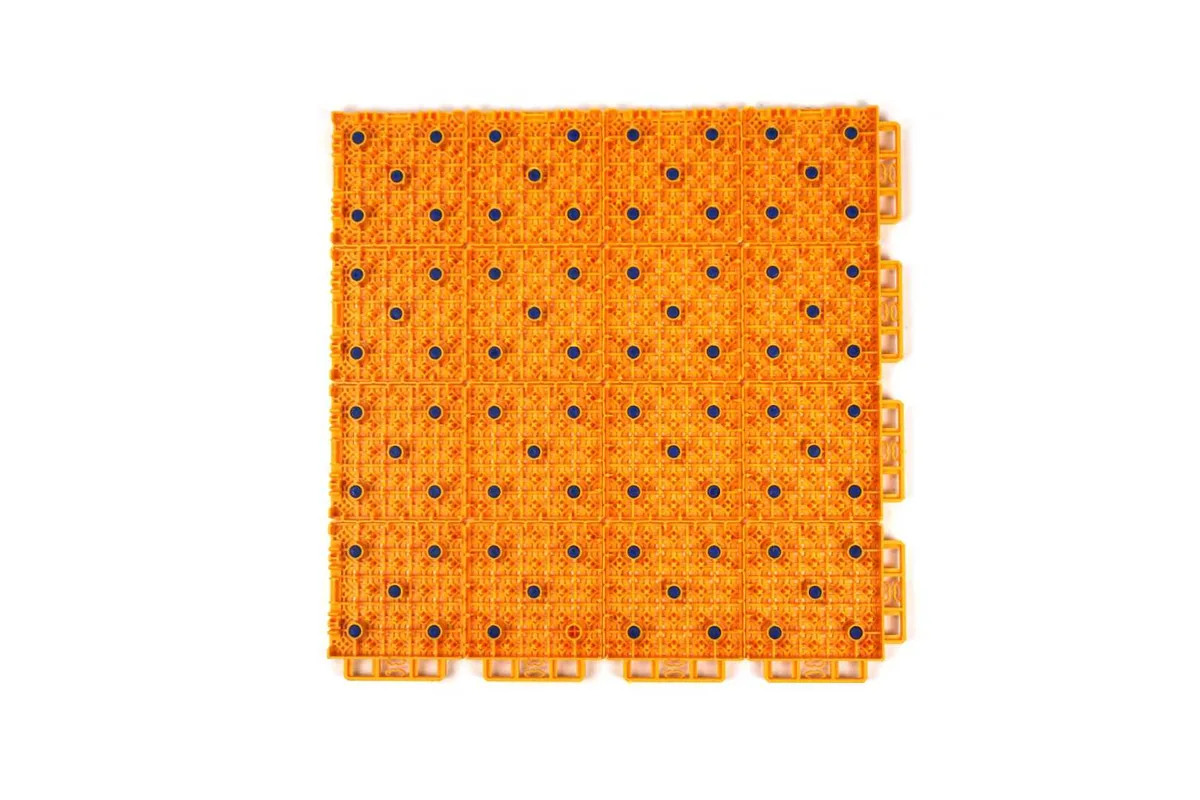 Underside of a MAX Q1 court tile showing its blue cushion pads
