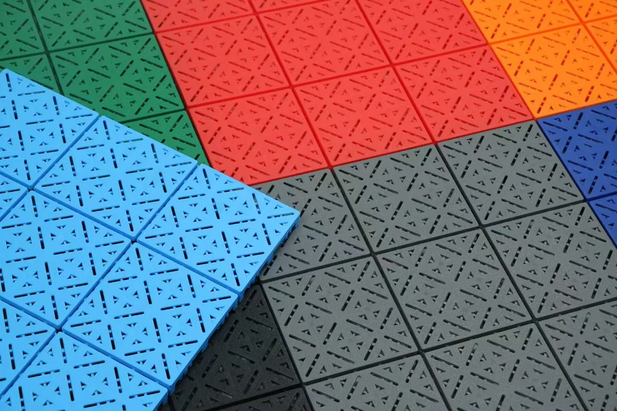 Close-up of MAX X1 tile surface patterns in blue, green, red, orange and grey